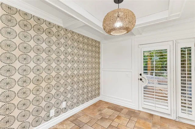 an empty room with wooden floor and fan
