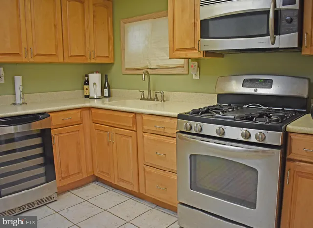 a kitchen with cabinets appliances and a sink