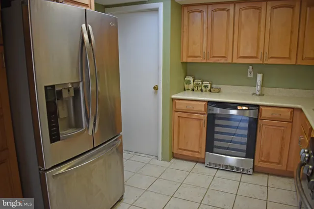 a kitchen with stainless steel appliances granite countertop a refrigerator and a stove