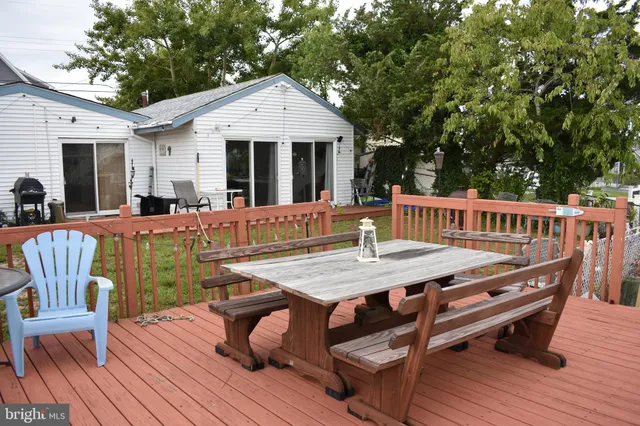 a view of a house with pool and chairs