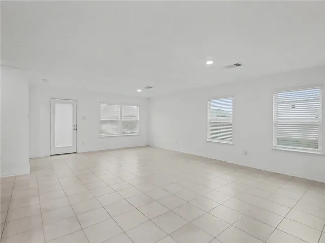 an empty room with windows and closet