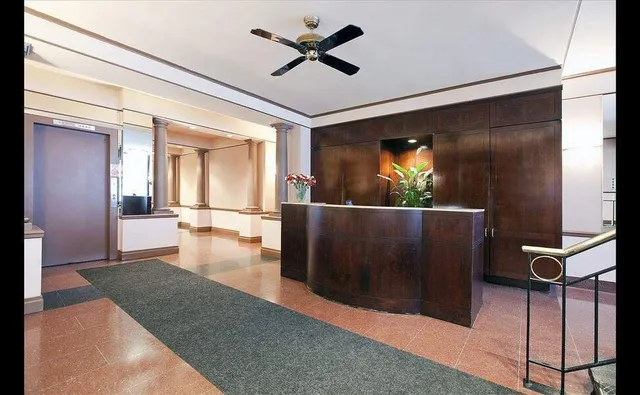 a view of a porch with wooden floor and a ceiling fan