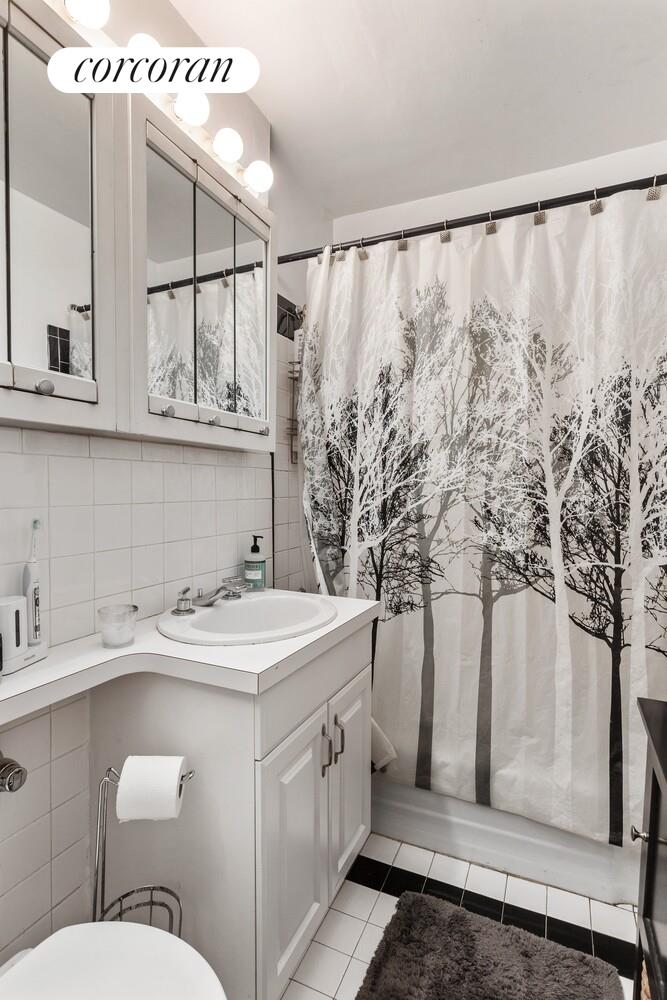 25 West 13th Street, Unit 3FN Manhattan, NY 10011 - Photo 12 of 20 a bathroom with a sink and mirror