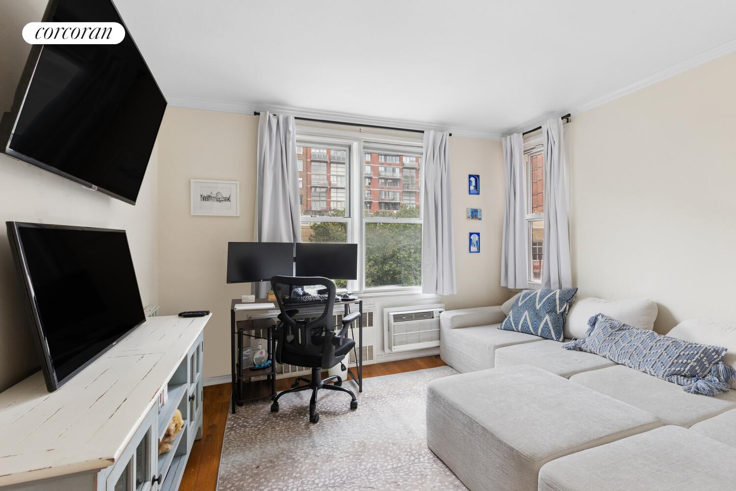 25 West 13th Street, Unit 3FN Manhattan, NY 10011 - Photo 2 of 20 a living room with furniture and a flat screen tv