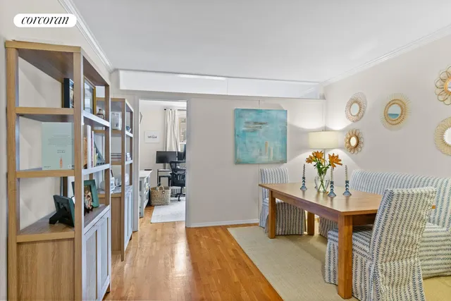 a dining room with furniture and wooden floor