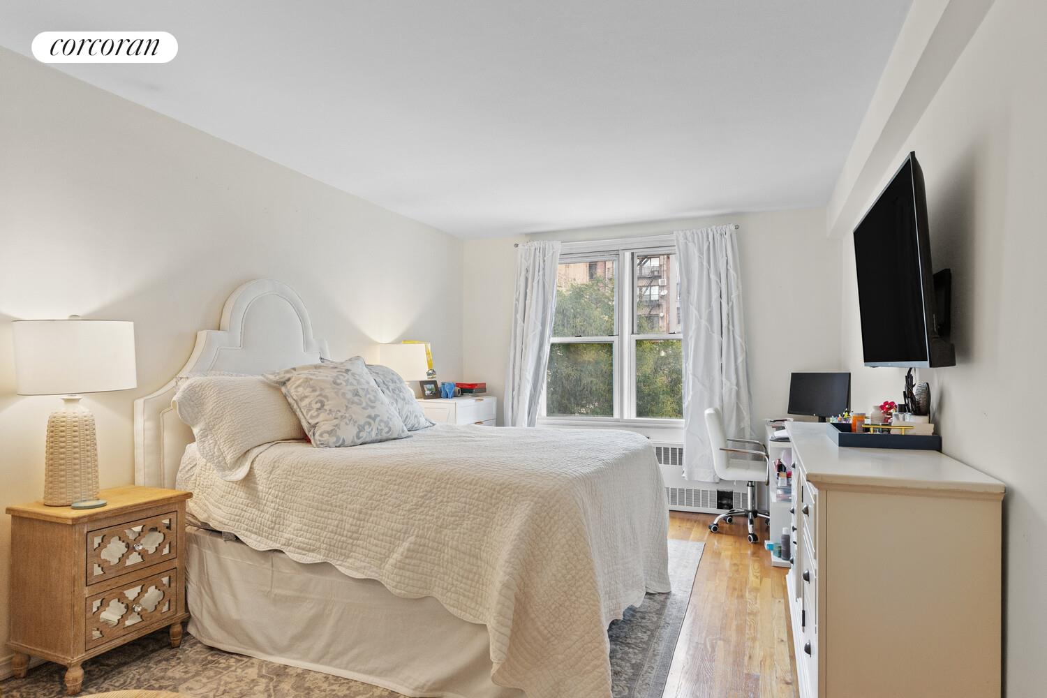 25 West 13th Street, Unit 3FN Manhattan, NY 10011 - Photo 5 of 20 a bedroom with a bed and a flat screen tv