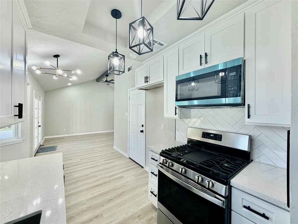 1710 Beaver Bend Road Houston, TX 77088 - Photo 11 of 32 a kitchen with stainless steel appliances granite countertop a sink a stove top oven a chimney and a granite counter tops