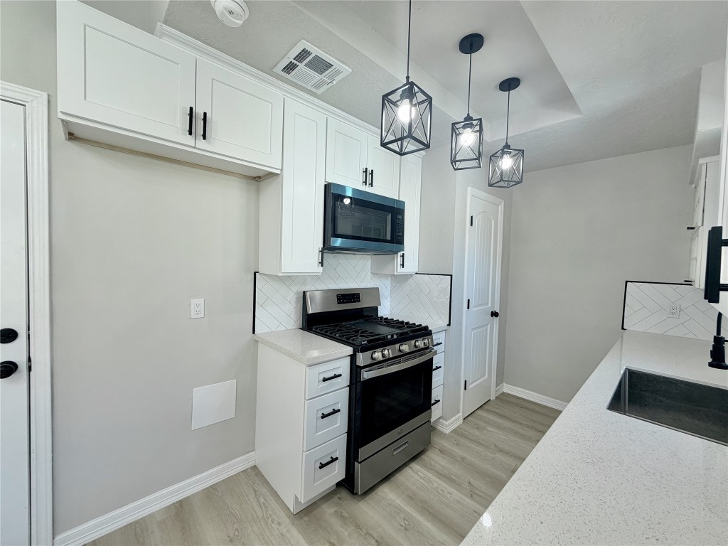 1710 Beaver Bend Road Houston, TX 77088 - Photo 12 of 32 a kitchen with stainless steel appliances a stove and a refrigerator