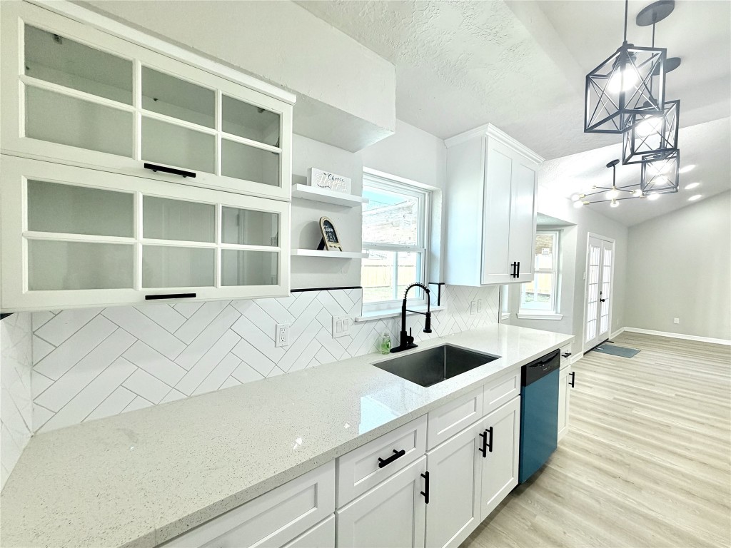 1710 Beaver Bend Road Houston, TX 77088 - Photo 13 of 32 a kitchen with a sink and chandelier