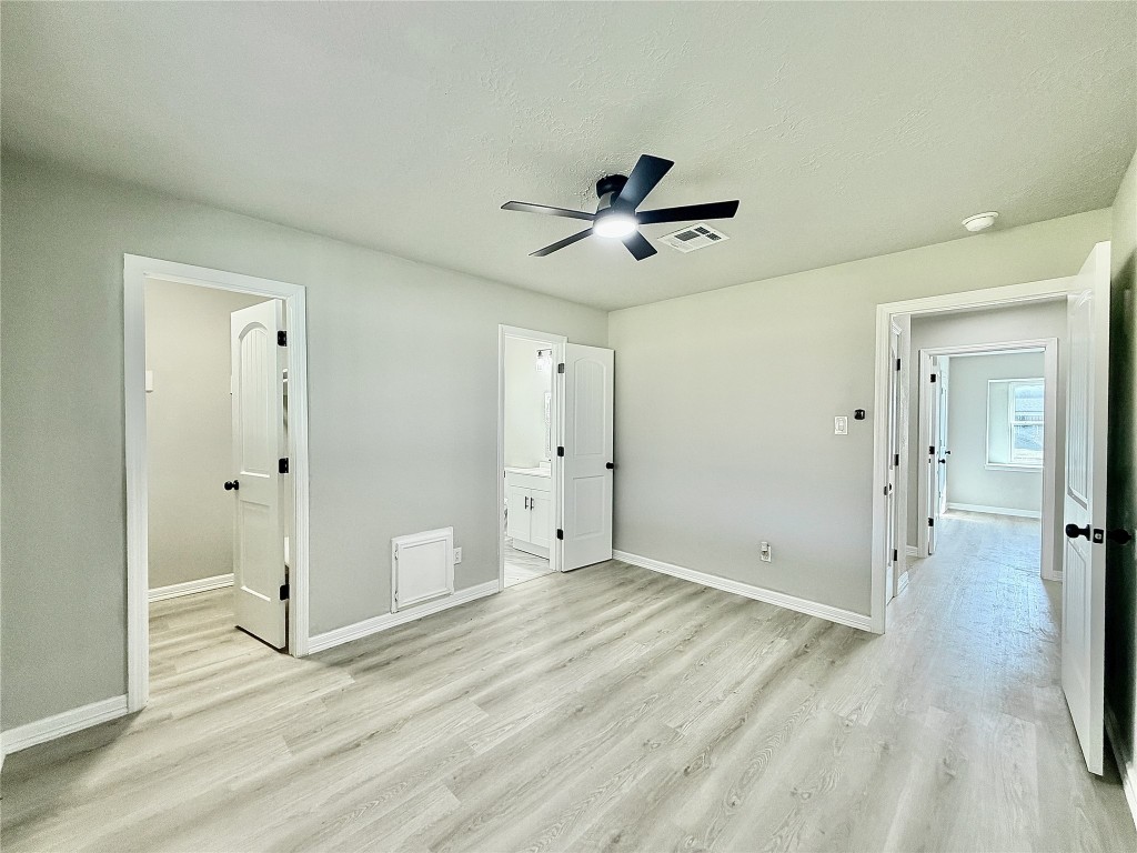 1710 Beaver Bend Road Houston, TX 77088 - Photo 17 of 32 a view of empty room with wooden floor and ceiling fan