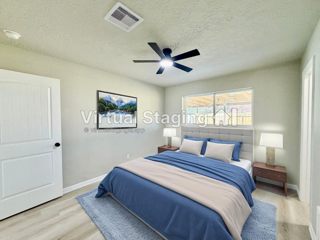 1710 Beaver Bend Road Houston, TX 77088 - Photo 21 of 32 a bedroom with a large bed and a large window