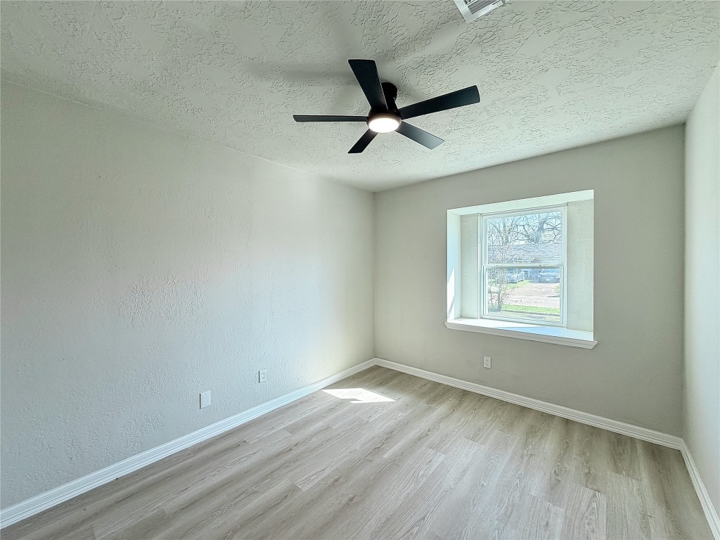 1710 Beaver Bend Road Houston, TX 77088 - Photo 24 of 32 wooden floor in an empty room with a window