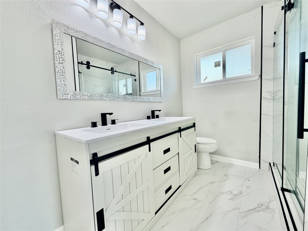 1710 Beaver Bend Road Houston, TX 77088 - Photo 25 of 32 a bathroom with a sink toilet and mirror
