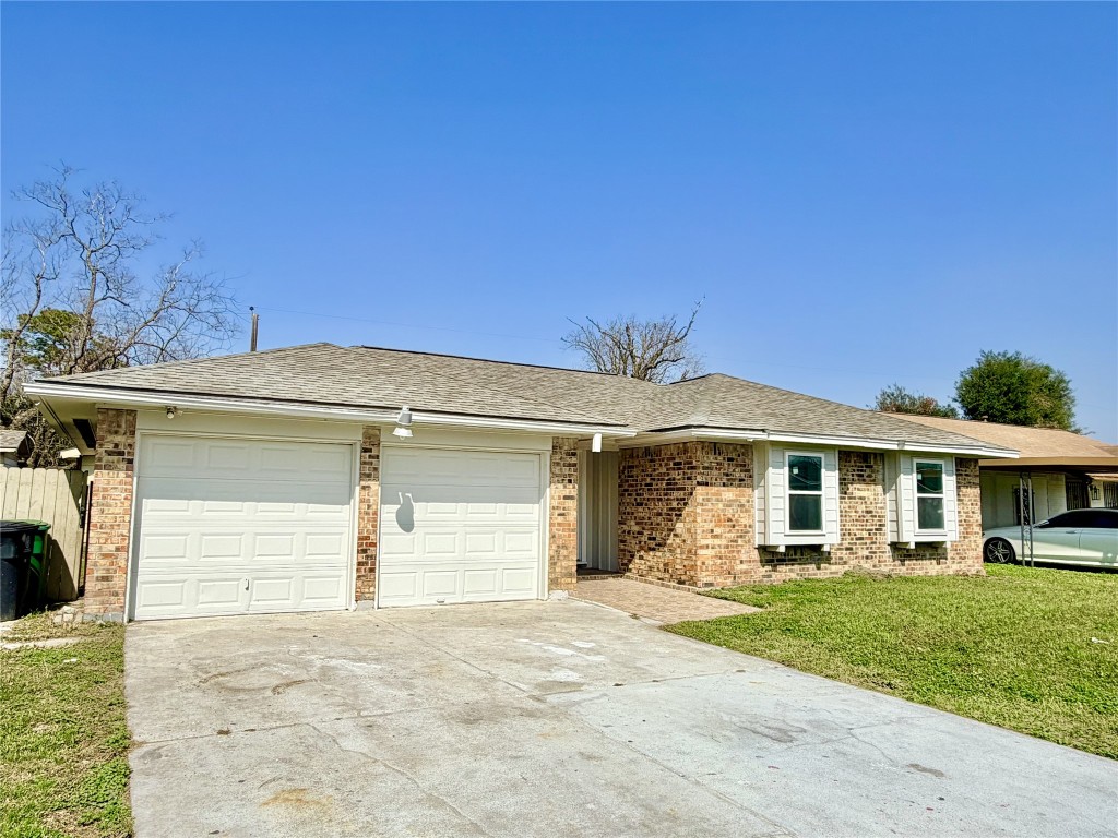 1710 Beaver Bend Road Houston, TX 77088 - Photo 27 of 32 a front view of a house with a yard and garage
