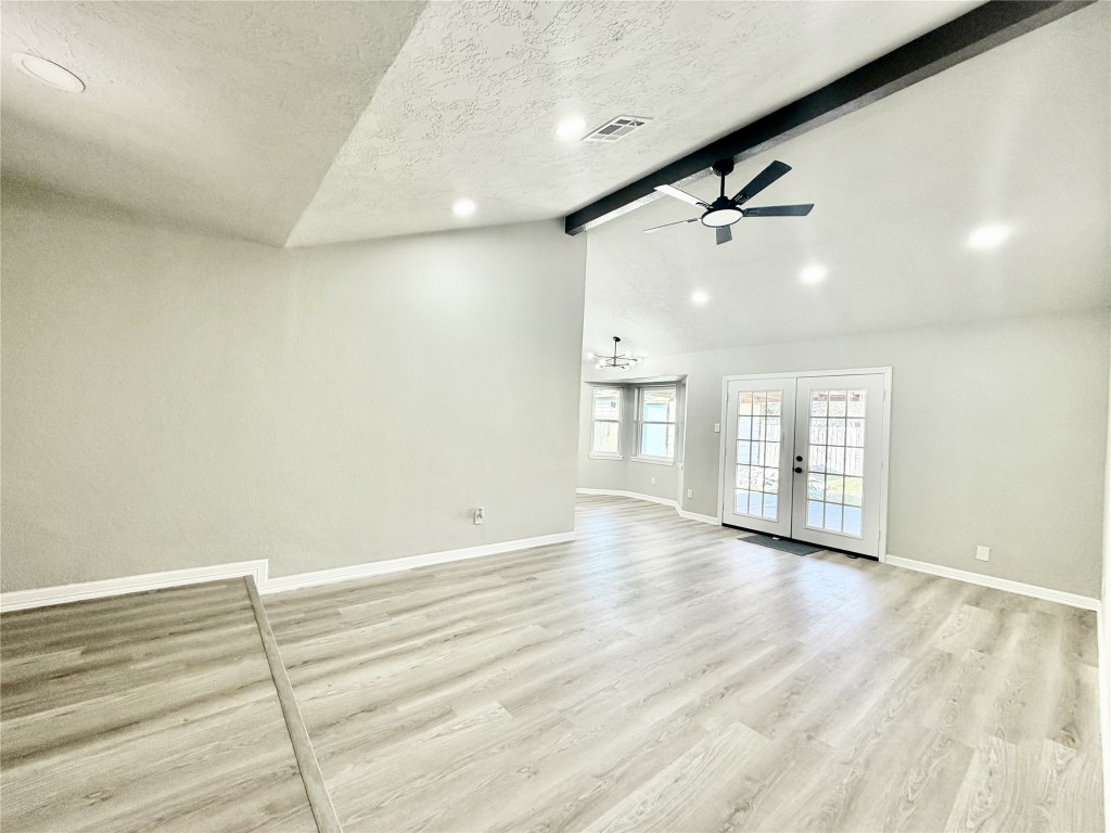 1710 Beaver Bend Road Houston, TX 77088 - Photo 6 of 32 an empty room with wooden floor and windows