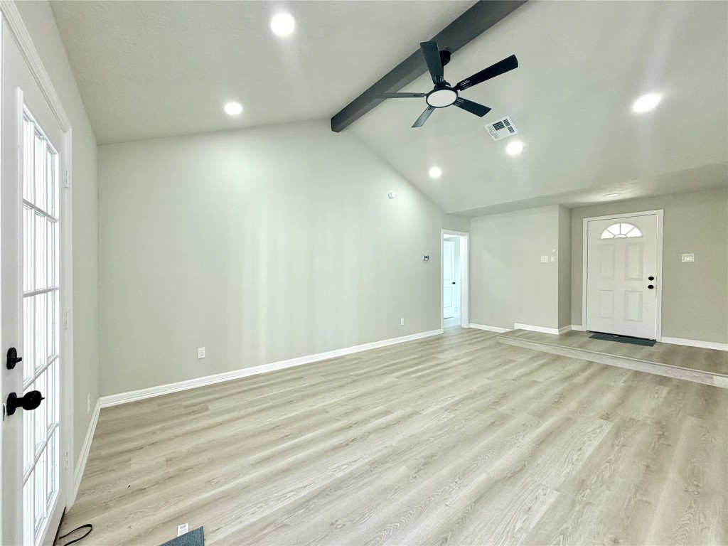 1710 Beaver Bend Road Houston, TX 77088 - Photo 7 of 32 wooden floor in an empty room with a window
