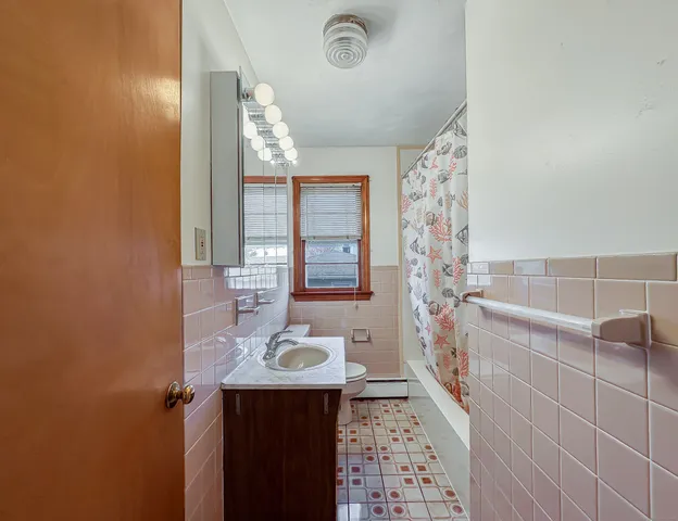 a bathroom with a sink a mirror and shower