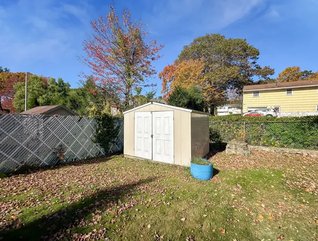 a backyard of a house with a yard and outdoor seating