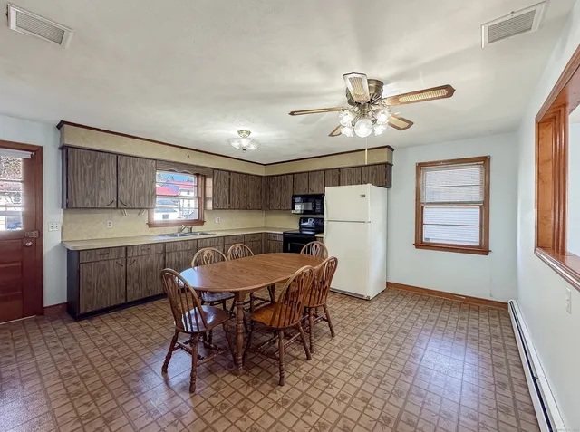 a dining room with furniture a window and kitchen view