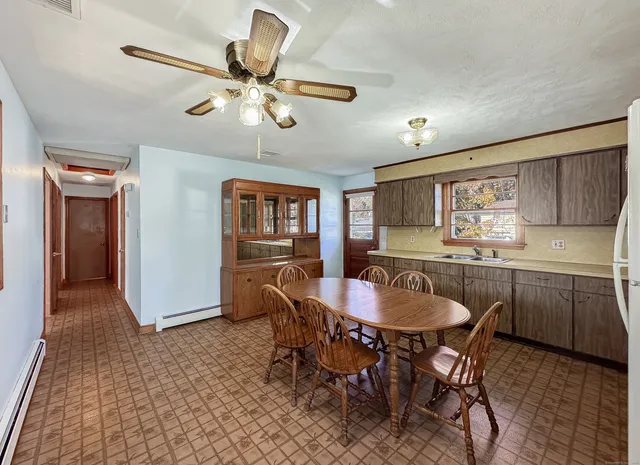 a dining room with furniture and window