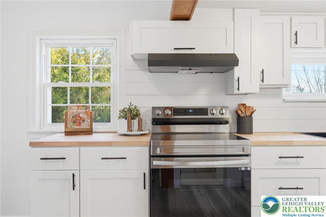 292 Walter Road Chalfont, PA 18914 - Photo 17 of 35 a kitchen with a stove and white cabinets