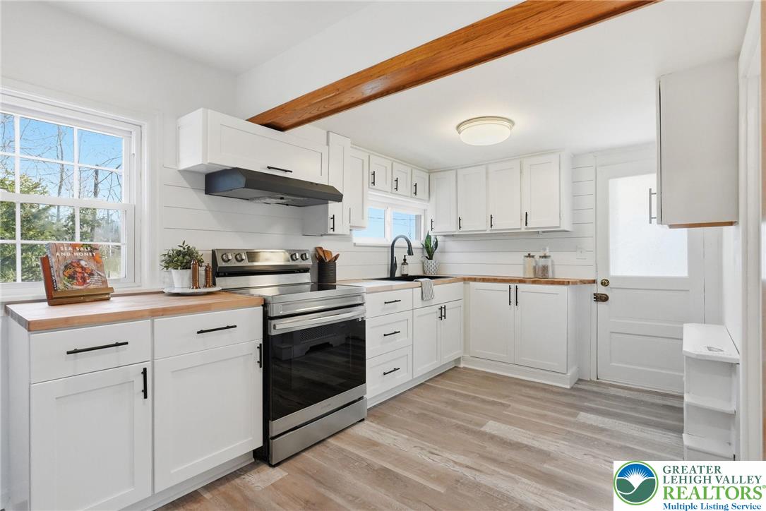 292 Walter Road Chalfont, PA 18914 - Photo 18 of 35 a kitchen with stainless steel appliances granite countertop a sink and cabinets with wooden floors