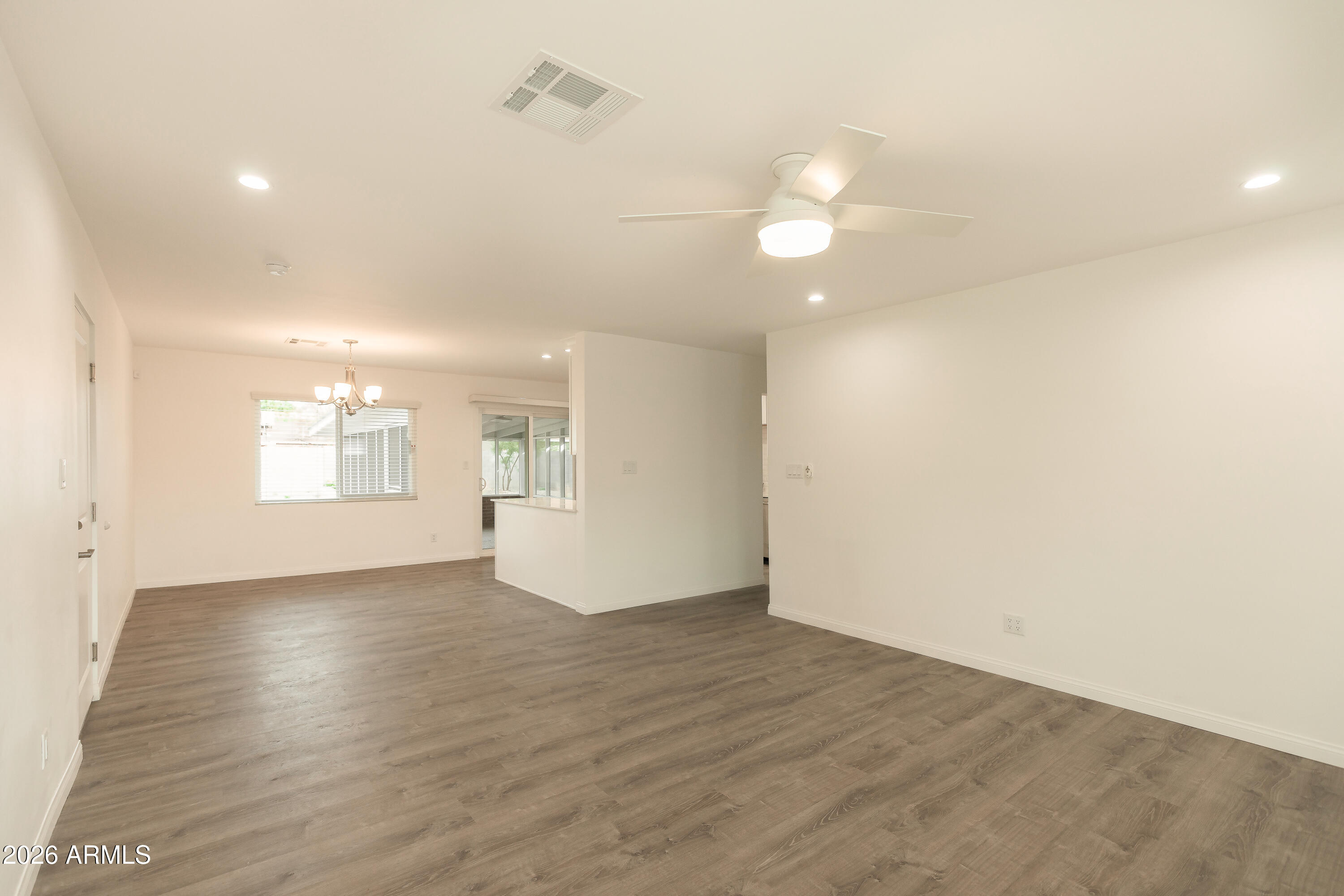 2226 East Devonshire Avenue Phoenix, AZ 85016 - Photo 5 of 17 an empty room with wooden floor and windows