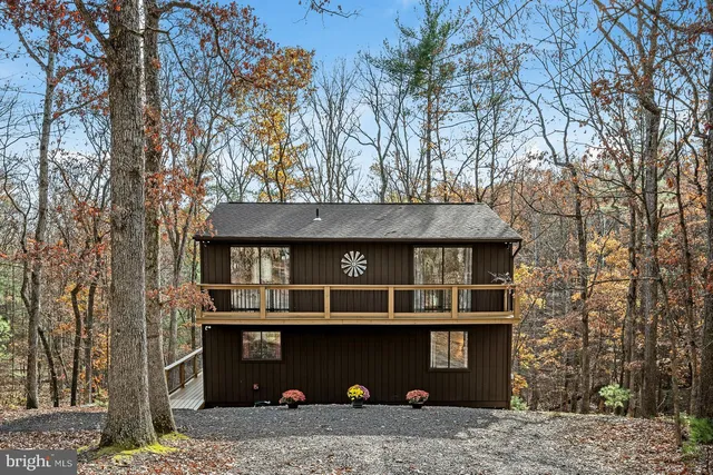 a view of a stone house with large windows