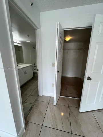 a view of bathroom with a sink and mirror