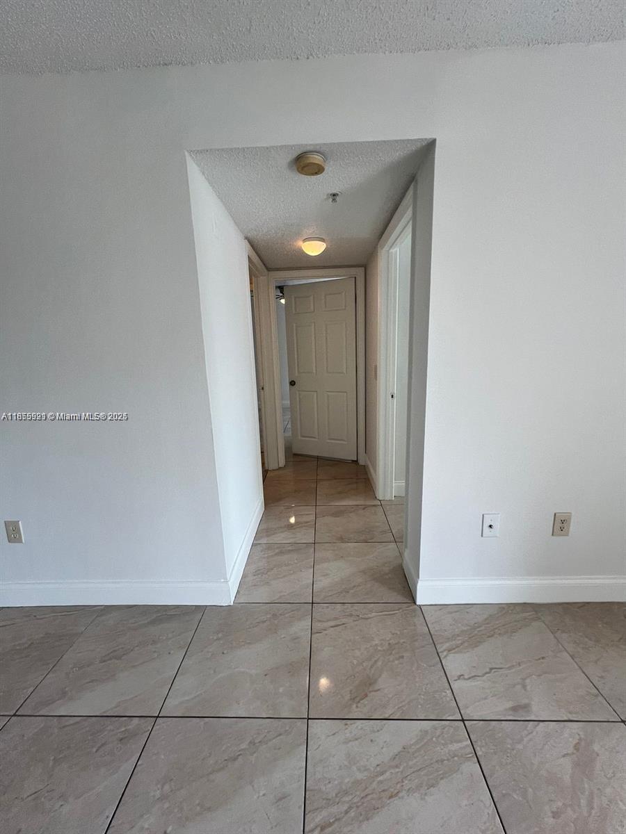 5065 Wiles Road, Unit 103 Coconut Creek, FL 33073 - Photo 15 of 20 a view of a hallway