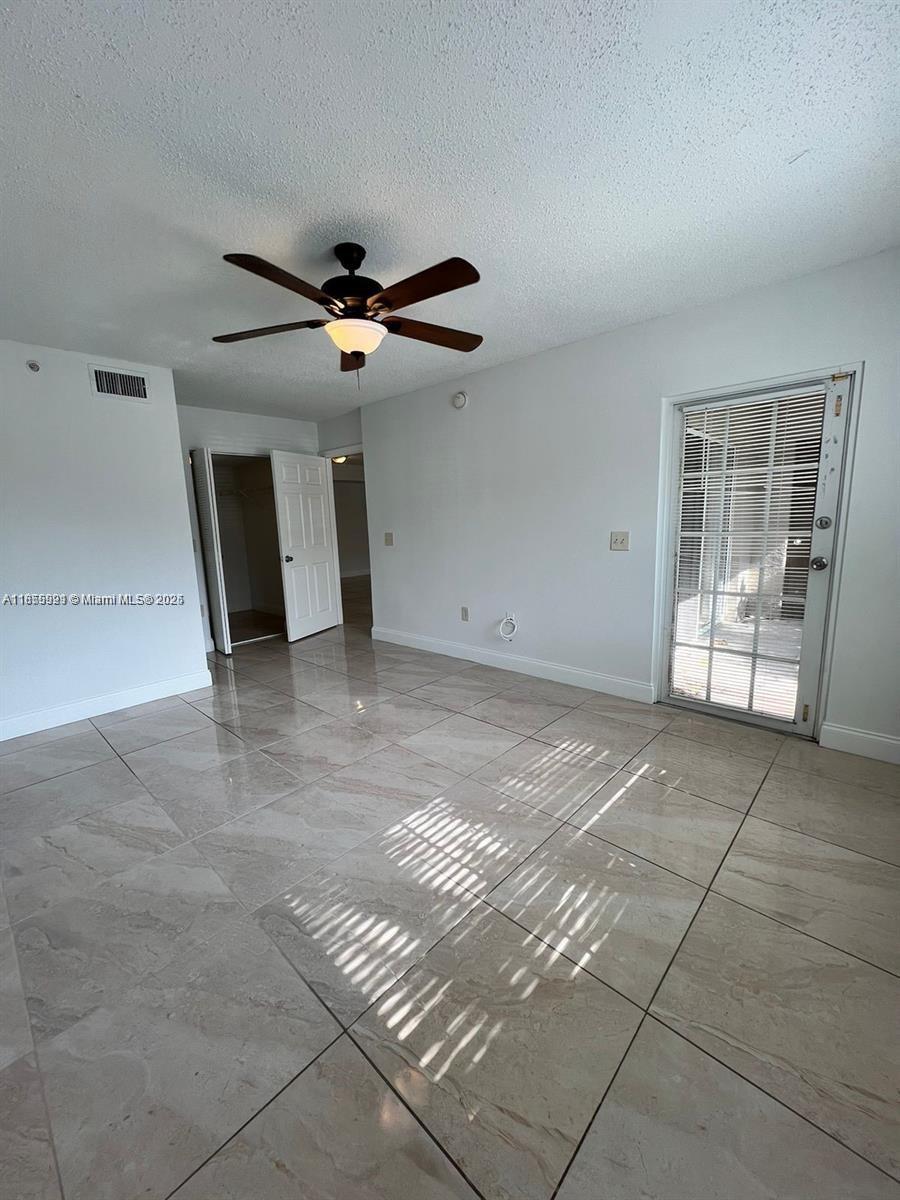 5065 Wiles Road, Unit 103 Coconut Creek, FL 33073 - Photo 19 of 20 a view of an empty room with a fireplace