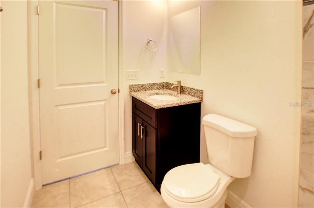 6952 Southwest 152nd Street Ocala, FL 34473 - Photo 14 of 25 a white toilet sitting next to a bathroom sink
