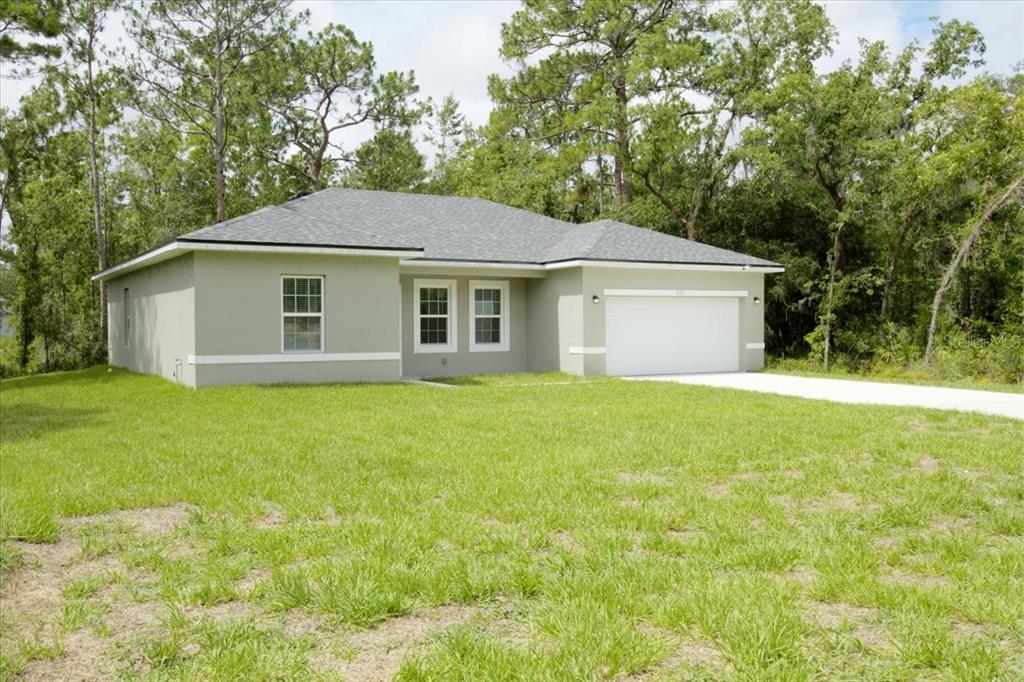 6952 Southwest 152nd Street Ocala, FL 34473 - Photo 22 of 25 a view of a house with yard and large trees