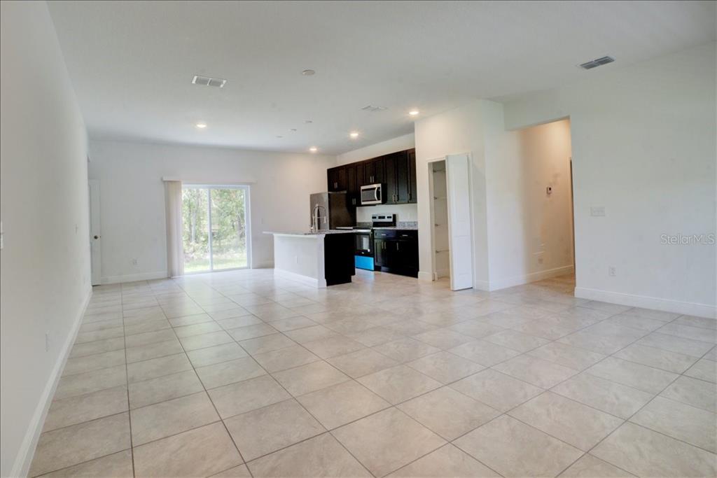 6952 Southwest 152nd Street Ocala, FL 34473 - Photo 3 of 25 a view of a electric appliances in kitchen and empty room with windows