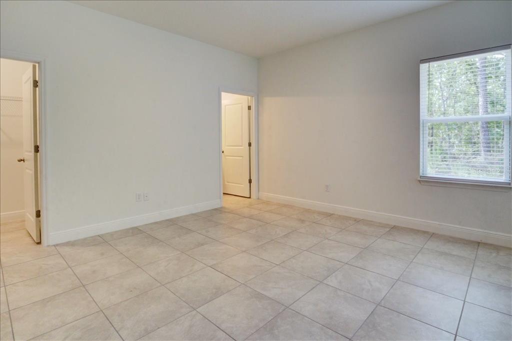 6952 Southwest 152nd Street Ocala, FL 34473 - Photo 8 of 25 an empty room with windows