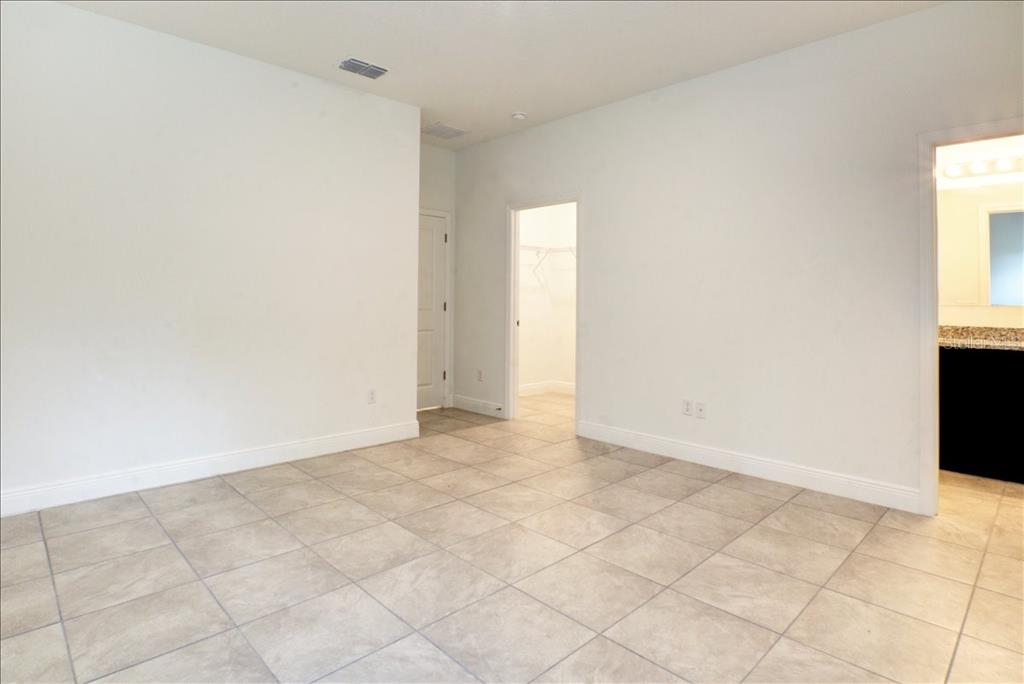 6952 Southwest 152nd Street Ocala, FL 34473 - Photo 9 of 25 an empty room with windows