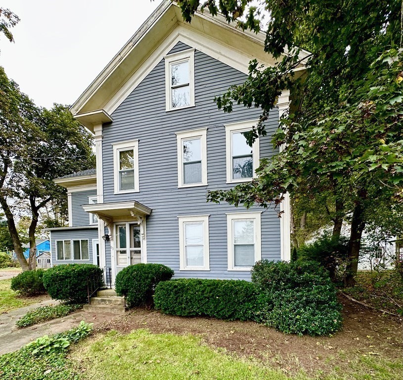 95 School Street Warren, MA 01083 - Photo 2 of 41 a front view of a house with a yard and potted plants