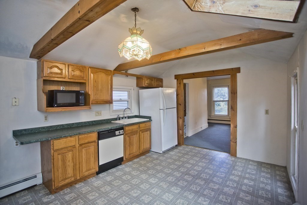 95 School Street Warren, MA 01083 - Photo 28 of 41 a view of a kitchen with a sink cabinet and floor to ceiling window