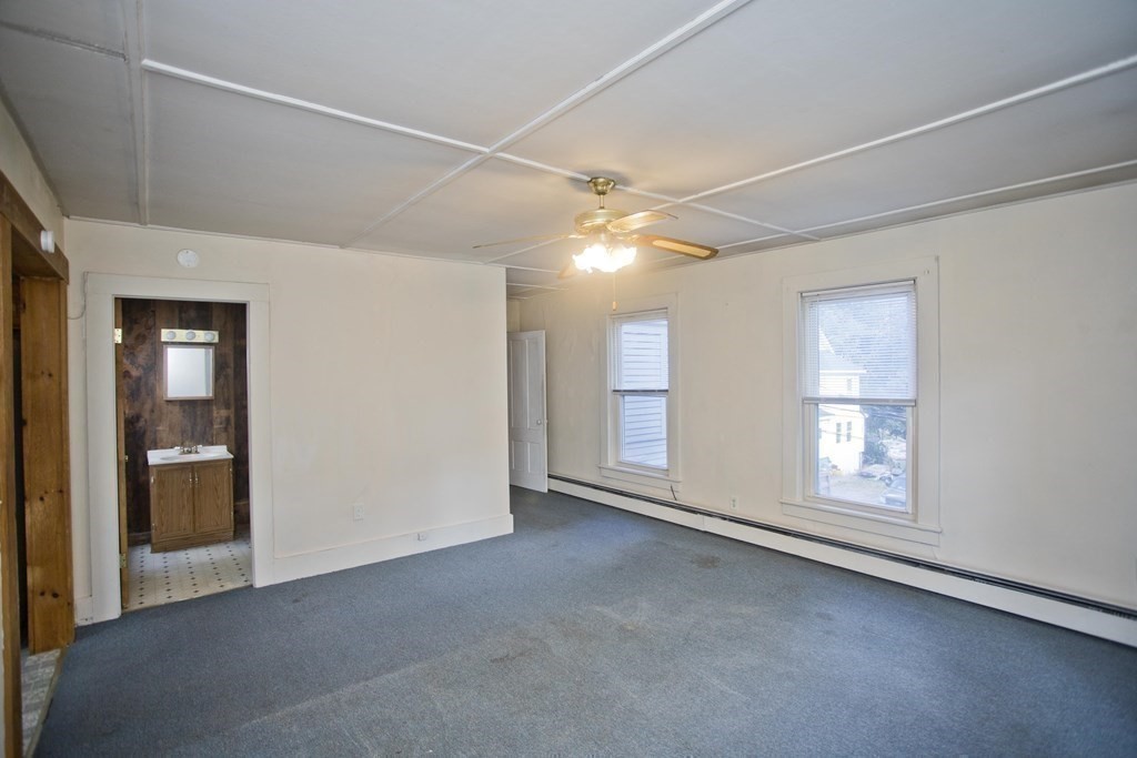 95 School Street Warren, MA 01083 - Photo 29 of 41 en empty room with windows and ceiling fan