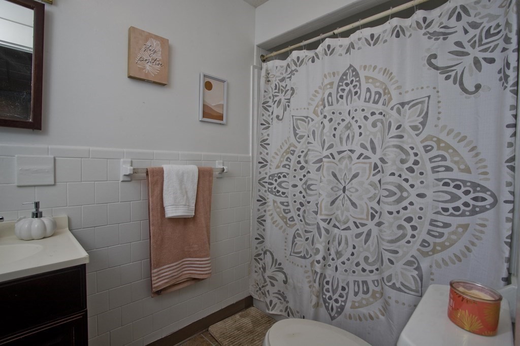 95 School Street Warren, MA 01083 - Photo 8 of 41 a bathroom with a toilet and a shower curtain