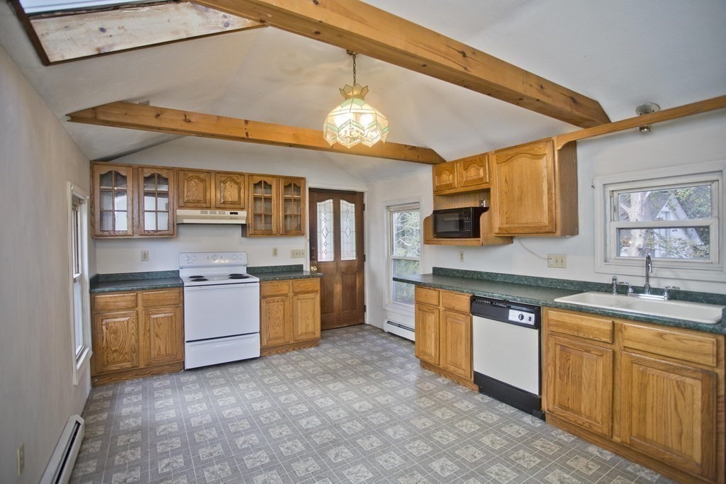 95 School Street Warren, MA 01083 - Photo 9 of 41 a large kitchen with cabinets a sink and stainless steel appliances