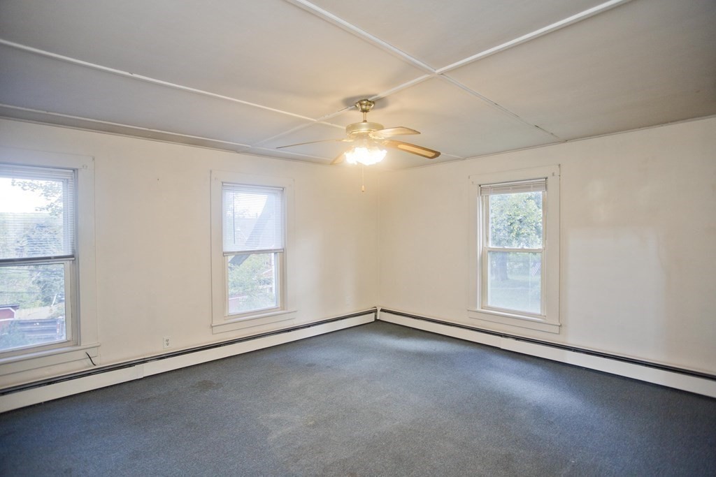 95 School Street Warren, MA 01083 - Photo 10 of 41 an empty room with chandelier fan and windows