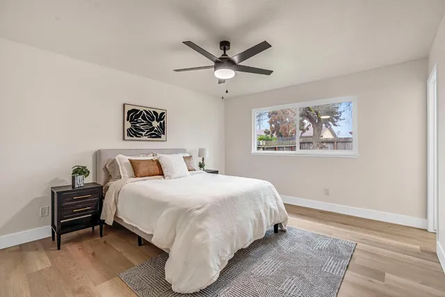 a bedroom with a bed and a painting on the wall