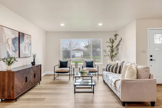 a living room with furniture and wooden floor