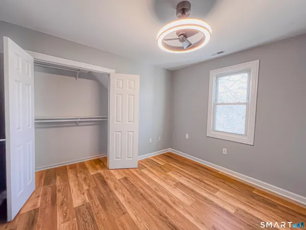a view of empty room with wooden floor