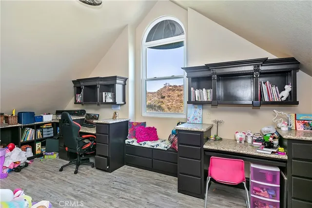 a bedroom with a bed gym equipment and a large window