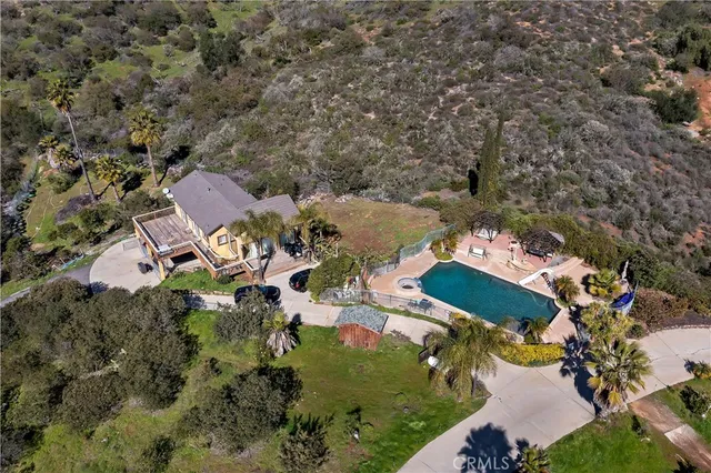 an aerial view of residential house with outdoor space and river