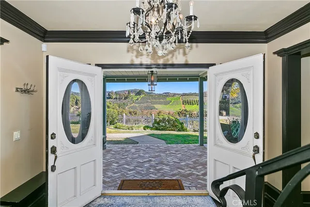 a view of a dining room with furniture wooden floor and chandelier