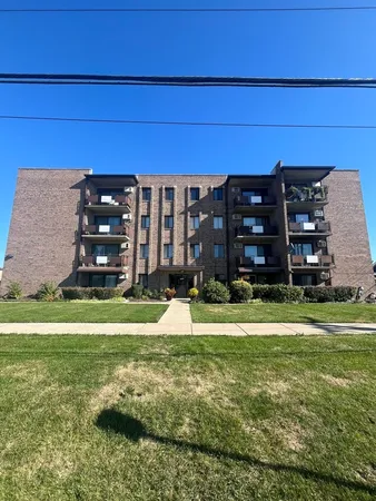 a view of a tall building with a yard