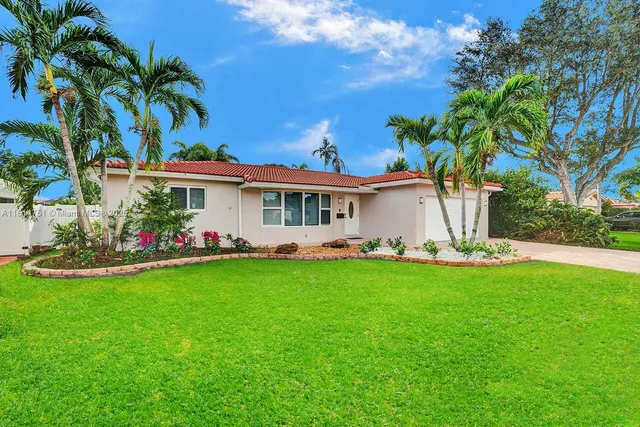 a view of a house with a yard and sitting area